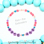 Friendship Embroidery Font: Friendship bracelet circle with colorful beads spelling Kate Ann stitched on white fabric