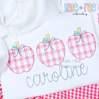 Girl's Plaid Filled Apple Trio Embroidery Design: Three pink plaid apples with bows above the name caroline in gray script on a white shirt