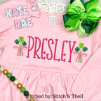 Shamrock Bouquet Mini Fill Embroidery Design: The name Presley in pink between two small shamrock bouquets with pink bows on a pink ruffled shirt