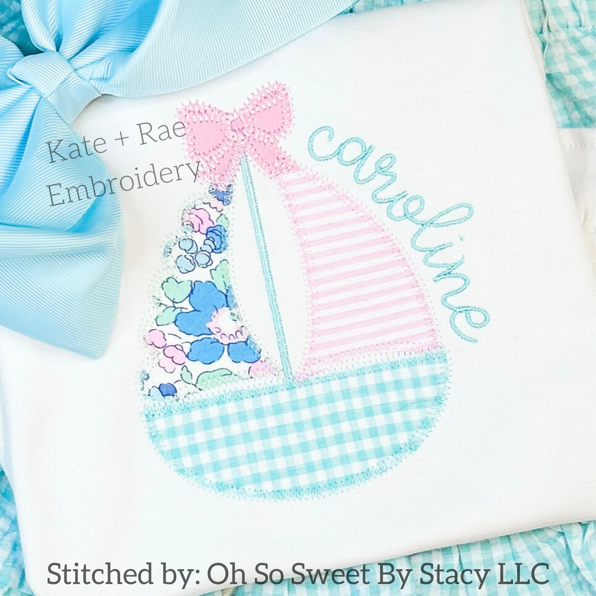 Girl's Scalloped Sailboat Zigzag Applique Embroidery Design: Scalloped sailboat with a pink bow and floral sails beside the name caroline in aqua script on a white shirt