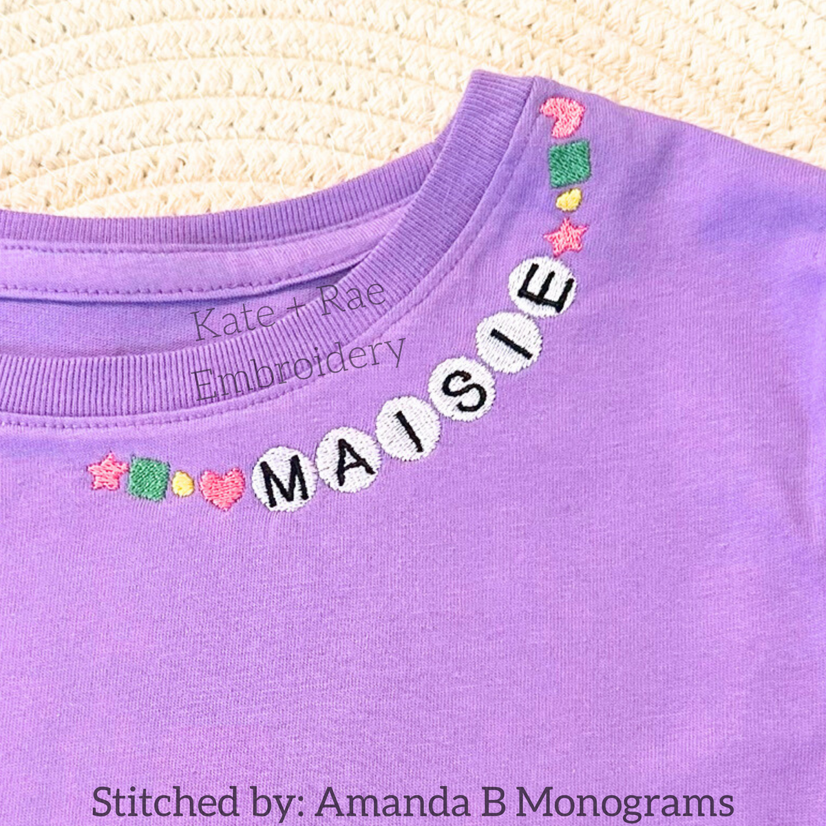 Friendship Embroidery Font: Friendship bracelet style beaded letters spelling Maisie around the collar of a purple shirt