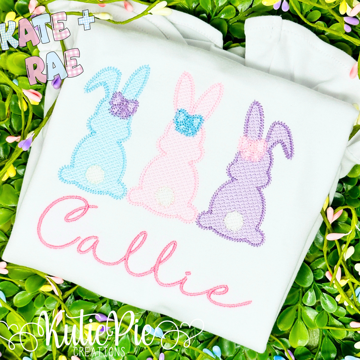 Girl's Easter Bunny Trio Sketch Stitch Embroidery Design: Pink, mint, and purple sketch stitch bunnies with bows above the name Callie in pink script on a white shirt