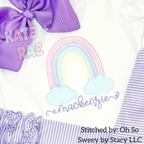 Rainbow Sketch Stitch Embroidery Design: Pastel rainbow with clouds above the name mackenzie in purple script on a white shirt with a purple bow