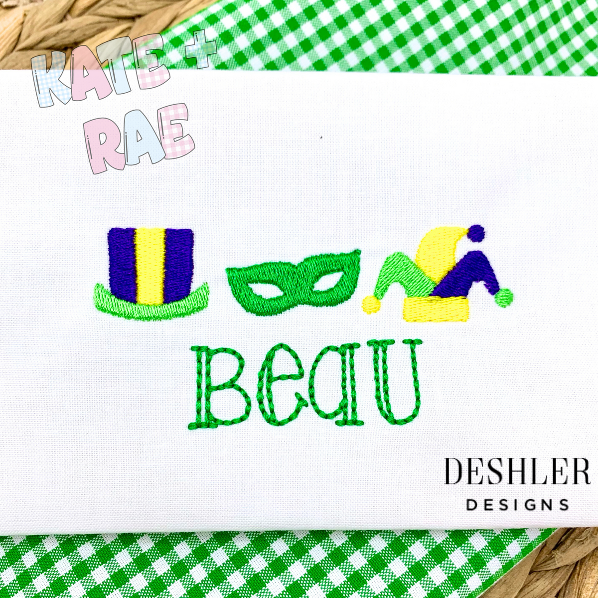 Boys Mardi Gras Fill Stitch Trio Embroidery Design: Mardi Gras top hat, green mask, and jester hat above the name Beau on white fabric with green gingham trim