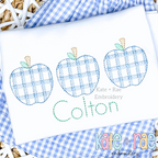 Boy's Plaid Filled Apple Trio Embroidery Design: Three blue plaid sketch stitch apples above the name Colton in green on a white shirt