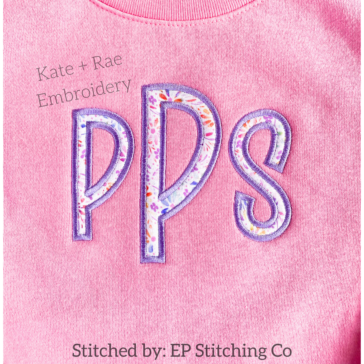 Kinley Satin Stitch Applique Embroidery Font: The letters PPS in purple floral satin applique letters on a pink sweatshirt