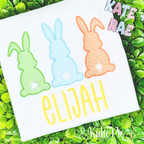 Boy's Easter Bunny Trio Sketch Stitch Embroidery Design: Green, blue, and orange sketch stitch bunnies with cotton tails above the name Elijah in yellow on a white shirt