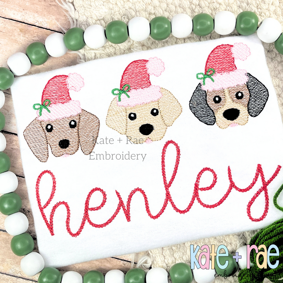 Santa Puppy Trio with Bows Sketch Stitch Embroidery Design: Three puppy faces wearing Santa hats with bows above the name henley in red script on a white shirt