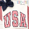 USA Star Filled Embroidery Design: The word USA in red star print collegiate applique letters with a navy outline on a white shirt