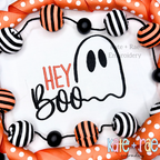 Hey Boo Halloween Embroidery Design: The words Hey Boo with a smiling ghost outline stitched on a white shirt