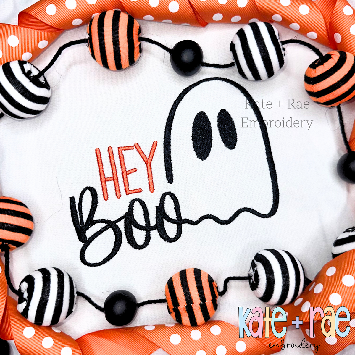 Hey Boo Halloween Embroidery Design: The words Hey Boo with a smiling ghost outline stitched on a white shirt