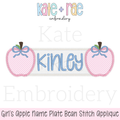 Girl's Apple Name Frame with Bows Zigzag Applique Embroidery Design: Design preview of two pink apples with blue bows framing a name plate reading Kinley