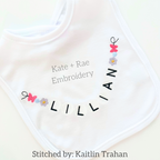 Friendship Embroidery Font: Friendship bracelet style beaded letters spelling Lillian around the neckline of a white baby bib