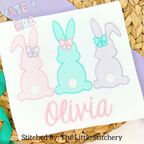 Girl's Easter Bunny Trio Sketch Stitch Embroidery Design: Pink, mint, and lavender sketch stitch bunnies with bows above the name Olivia in pink script on a white shirt