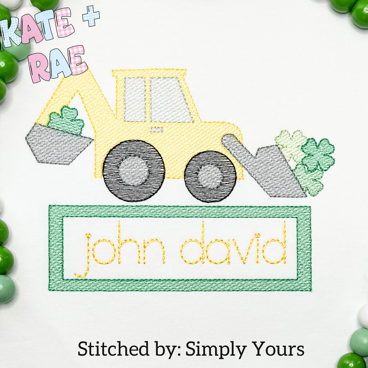 Shamrock Backhoe Sketch Stitch Embroidery with Name Plate: Sketch stitch backhoe with shamrocks above the name john david in a green name plate on a white shirt