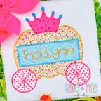 Pumpkin Carriage Zigzag Applique Embroidery Design: Pumpkin carriage applique with a pink crown and the name hollynn on a white shirt