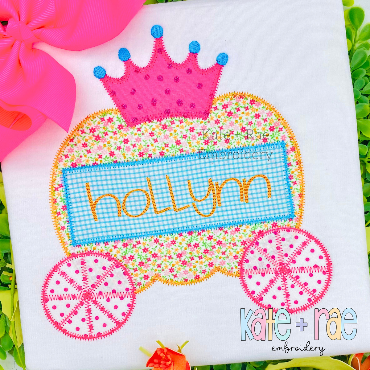 Pumpkin Carriage Zigzag Applique Embroidery Design: Pumpkin carriage applique with a pink crown and the name hollynn on a white shirt