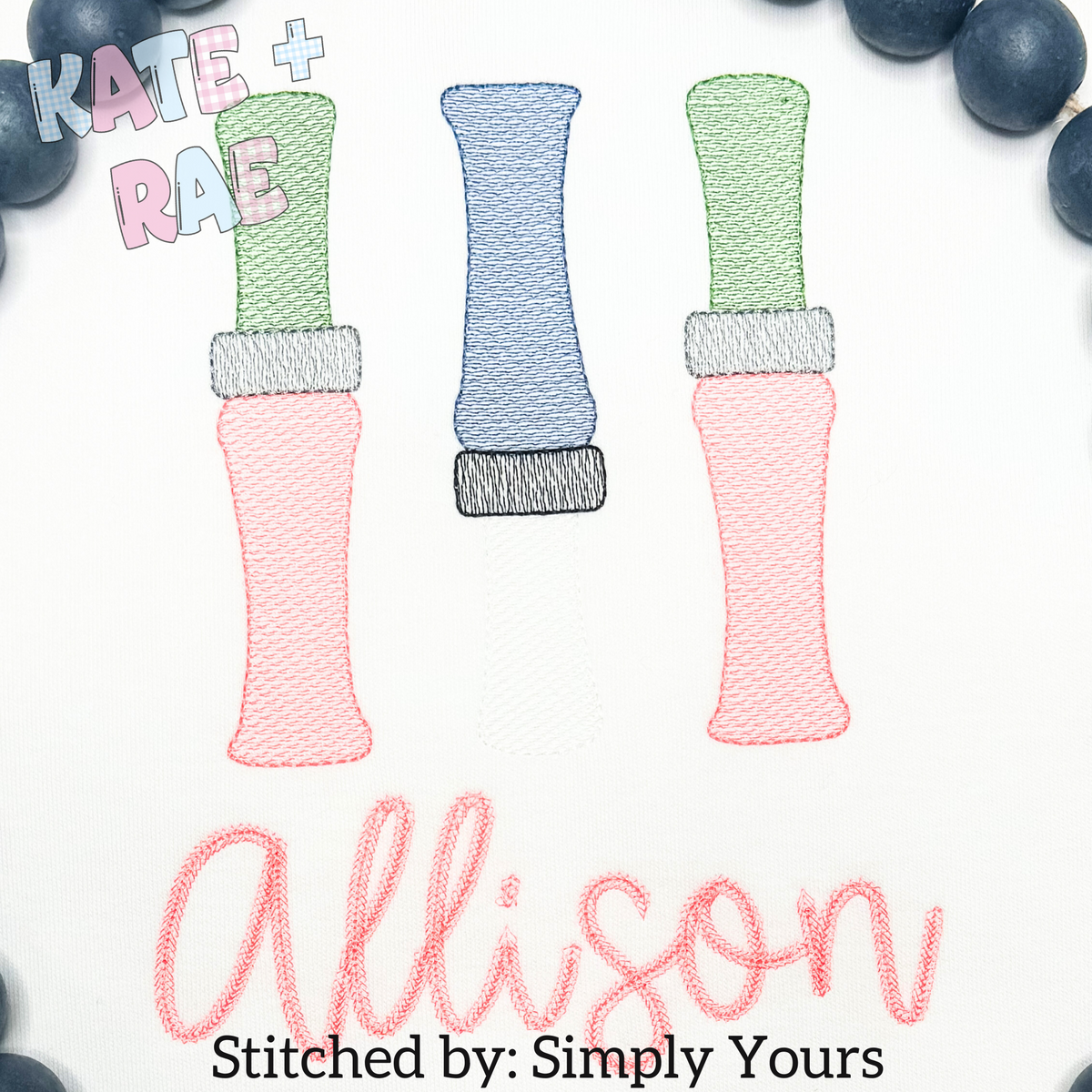 Duck Call Sketch Stitch Embroidery Design: Three sketch stitch duck calls in green, blue, and pink above the name Allison in pink script on white fabric