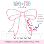 Kinley Bow Zigzag Stitch Applique Embroidery Design: Design preview of a pink zigzag bow with the name kinley on the tail in the Hello satin stitch font