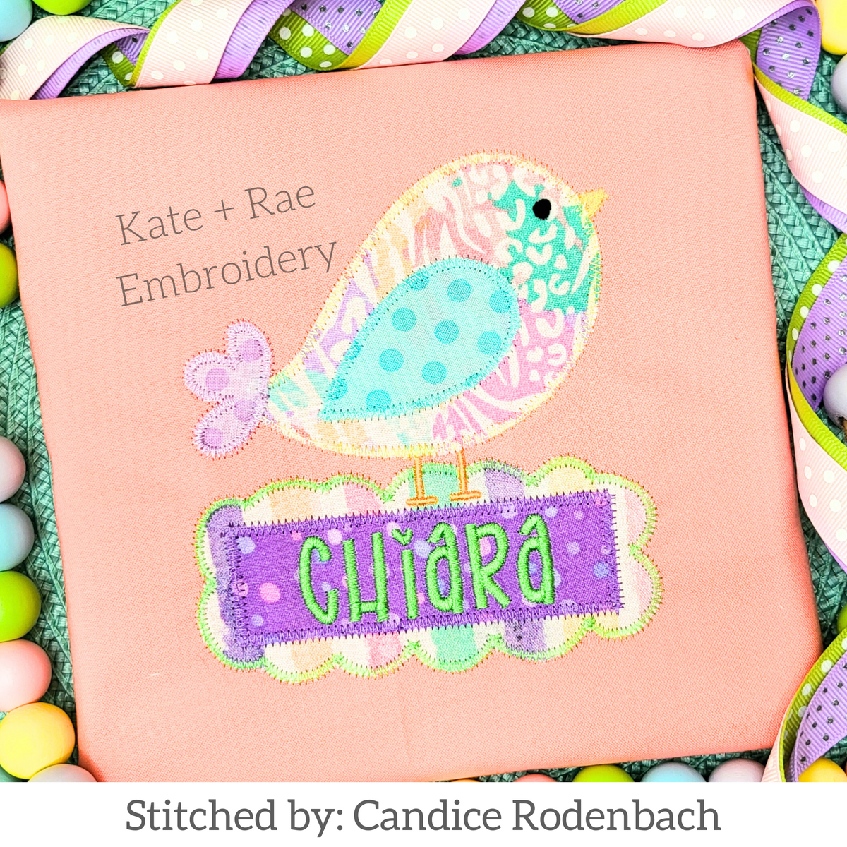 Spring Doodle Bird Zigzag Applique Embroidery Design: Patterned applique bird on a purple scalloped name plate reading Chiara on a peach shirt