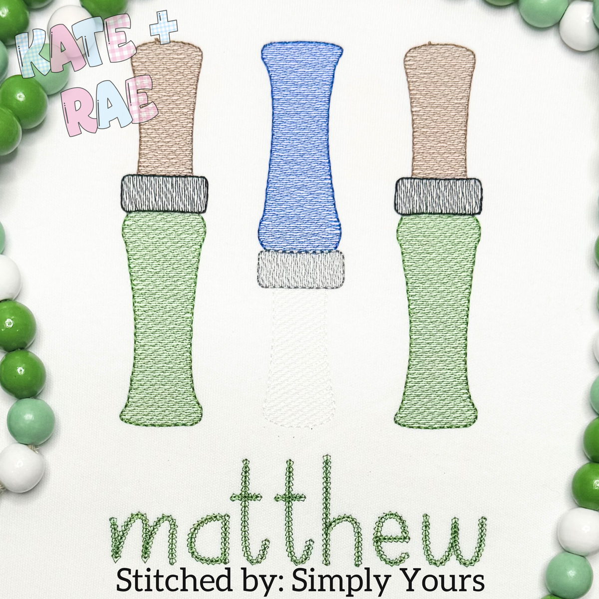 Duck Call Sketch Stitch Embroidery Design: Three sketch stitch duck calls in green, blue, and tan above the name matthew in green on white fabric