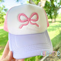Bow Mini 3D Puff Embroidery Design: Pink 3D puff mini bow on a white and lavender trucker hat