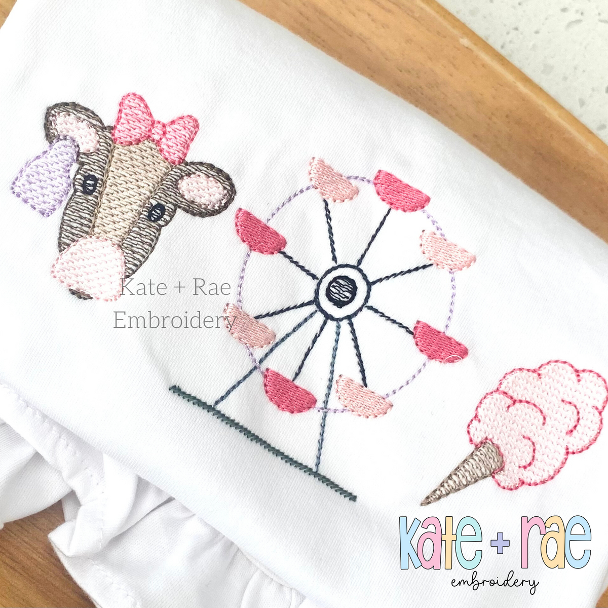 Girl's Fair with Cow Trio Sketch Stitch Embroidery Design: Cow with a pink bow, Ferris wheel, and cotton candy in sketch stitch on a white ruffled shirt