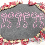Merritt Bow Trio Satin Stitch Applique Embroidery Design: Three pink outline Merritt bows on a gray sweatshirt