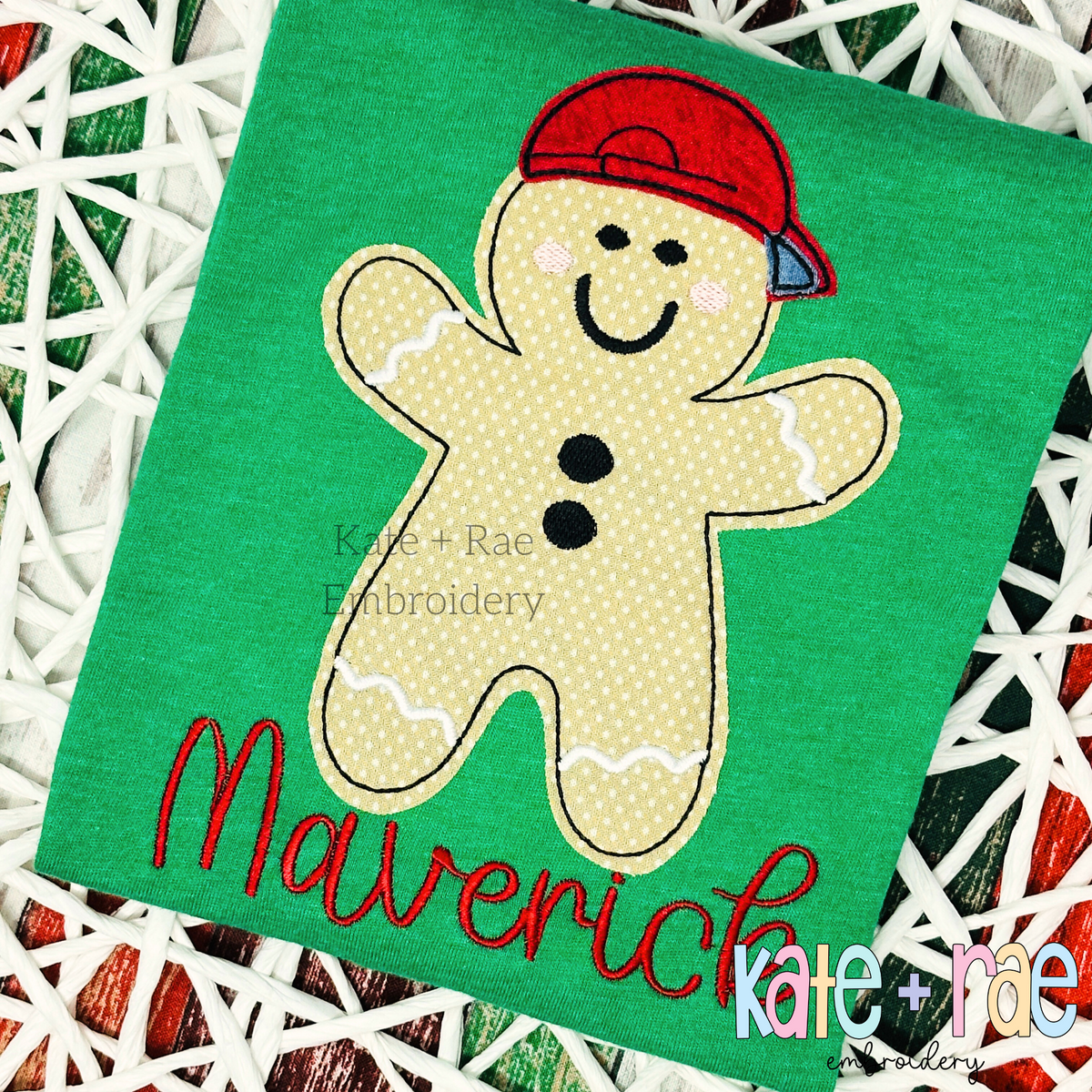 Boy's Gingerbread Man Bean Stitch Applique Embroidery Design: Gingerbread man applique wearing a red cap above the name Maverick in red script on a green shirt