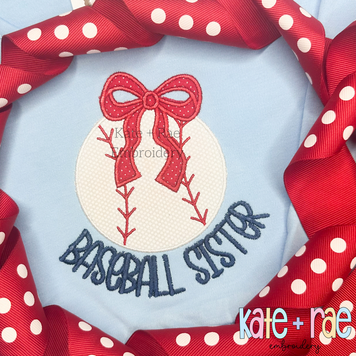 Baseball/ Softball with Merritt Bow Satin Stitch Embroidery Design: Baseball applique with a red polka dot bow above the words baseball sister in navy on a light blue shirt