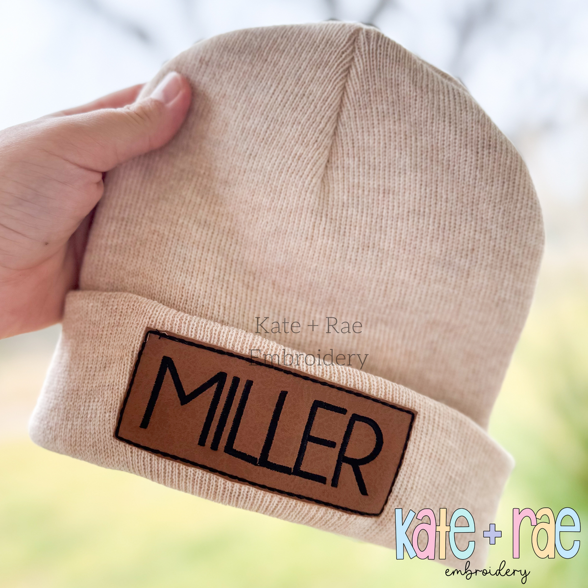 Rectangle Bean Stitch Applique Patch Embroidery Design for Hats & Beanies: Brown rectangle patch with the name MILLER on a tan knit beanie