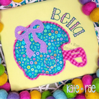 Football Helmet with Bow Double Zigzag Applique Embroidery Design: Teal floral football helmet applique with a purple bow and the name Bella on a yellow shirt