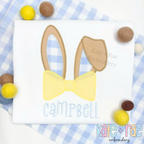 Easter Bunny Ears with Bow Tie Zigzag Stitch Applique Embroidery Design: Tan bunny ears with a yellow bow tie above the name Campbell on a white shirt with blue gingham