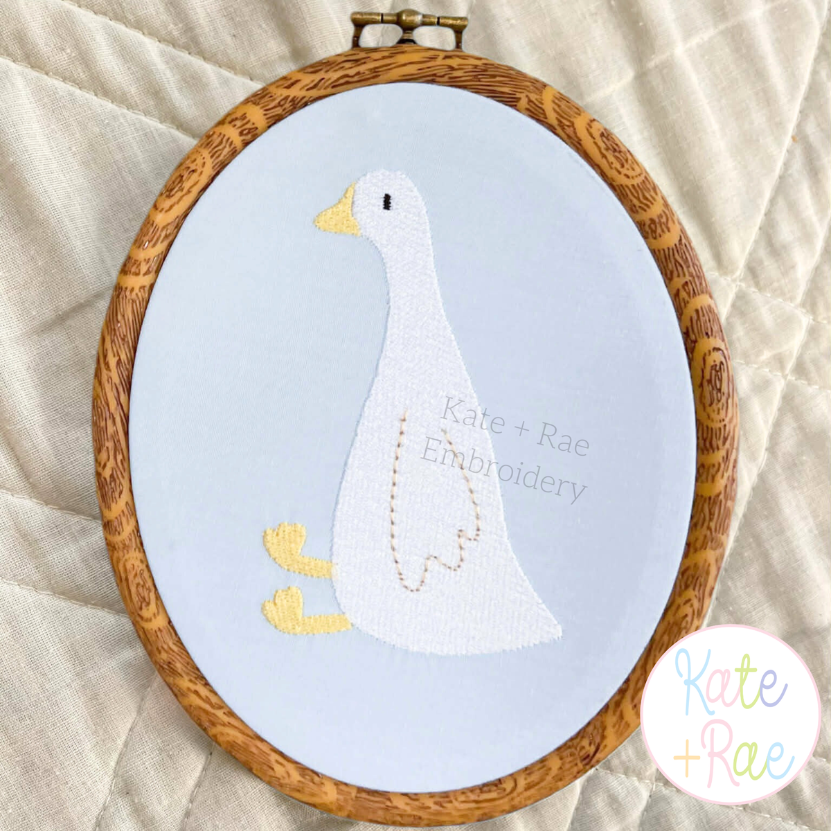 Goose Mini Fill Embroidery Design: White mini fill goose in an embroidery hoop