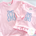 Addie Bow 3 Column Satin Stitch Applique Embroidery Design: Matching pink shirts with light blue Addie bow frames around M monograms