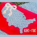 America Outline with Bow Zigzag Stitch Applique Embroidery Design: Blue floral America outline zigzag applique with a cream bow on a red shirt