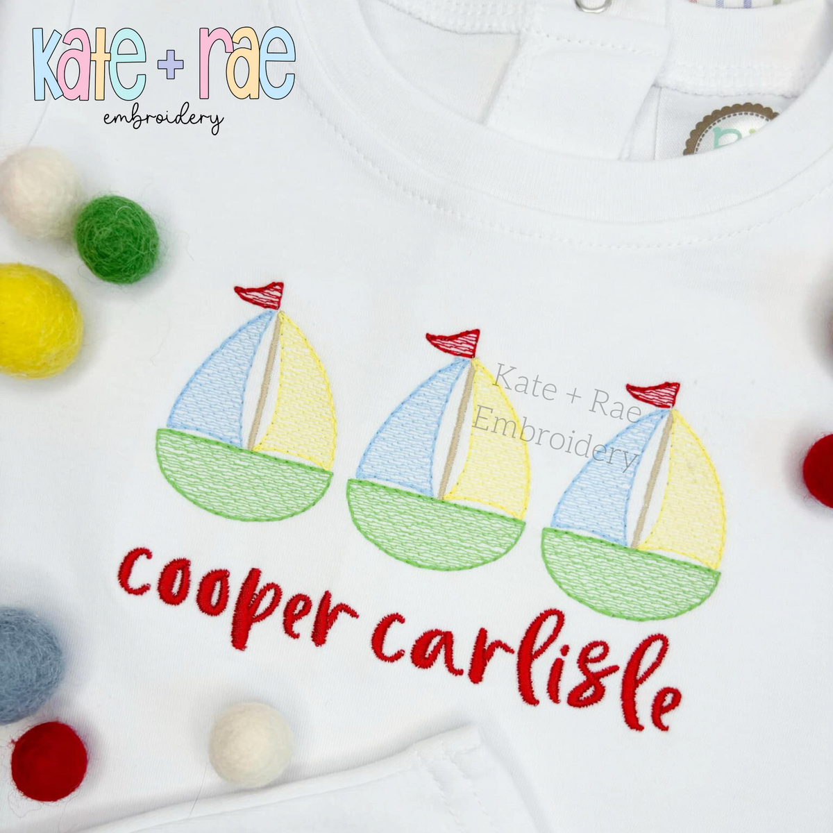 Sailboat Trio Sketch Stitch Embroidery Design: Close-up of three pastel sketch sailboats with red flags above the name cooper carlisle