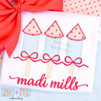 Girl's Firework Trio Zigzag Applique Embroidery Design: Light blue firework appliques with red star tops and bows above the name madi mills on a white shirt