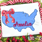 Blue America outline applique with a red bow and the name Amelia in red script on a white shirt