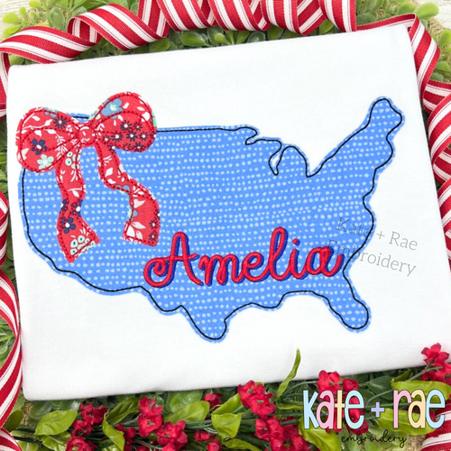 Blue America outline applique with a red bow and the name Amelia in red script on a white shirt
