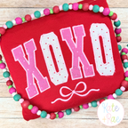 Curved XOXO with Bow Satin Stitch Applique Embroidery Design: The word XOXO in pink polka dot curved collegiate applique letters with a bow on a red sweatshirt