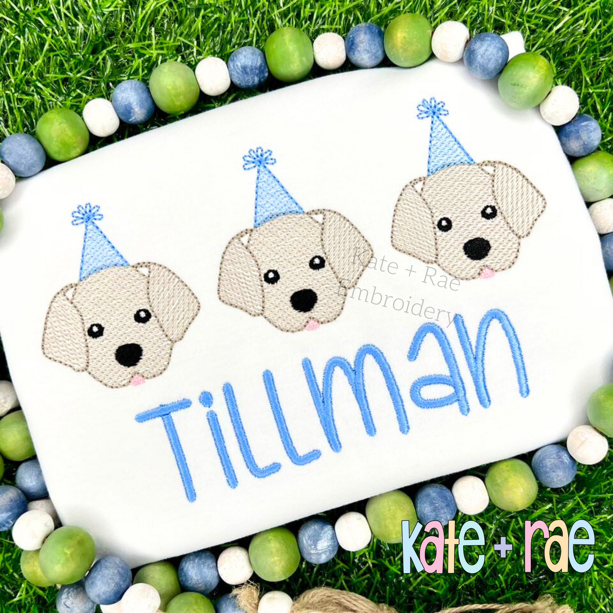 Birthday Labrador Puppy Trio Sketch Stitch Embroidery Design: Three yellow lab puppies in blue party hats above the name Tillman in blue on a white shirt