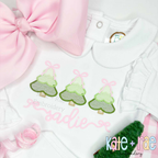 Girls Sketch Stitch Christmas Tree Trio with Satin Stitch Outline Embroidery Design: Three green sketch trees with pink bows above the name sadie in pink script on a white collared shirt