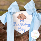 Birth/ Birthday Satin Stitch Applique Banner In The Hoop Embroidery Design: Birthday Boy banner with a goldendoodle hung from a black rail with blue bows