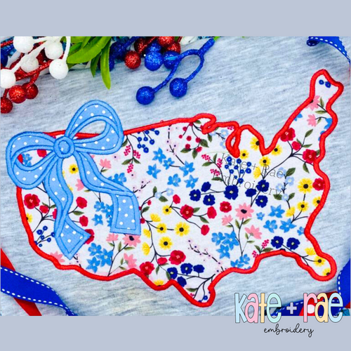 America Outline with Bow Satin Stitch Applique Embroidery Design: Floral America outline satin applique with a blue polka dot bow on a gray shirt