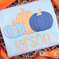 Boy's Fall Pumpkin Trio with Bows Zigzag Stitch Applique Machine Embroidery Design: Blue polka dot, orange striped, and navy pumpkin appliques above the name larson on a light blue shirt