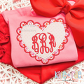 Scalloped Double Heart Satin Stitch Applique Embroidery Design: Red and pink scalloped heart applique around a pink script monogram on a pink sweatshirt