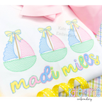 Sailboat Trio with Bows Sketch Stitch Embroidery Design: Close-up of three pastel sailboats with yellow bows above the name madi mills