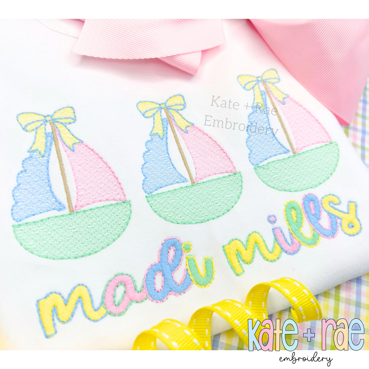 Sailboat Trio with Bows Sketch Stitch Embroidery Design: Close-up of three pastel sailboats with yellow bows above the name madi mills