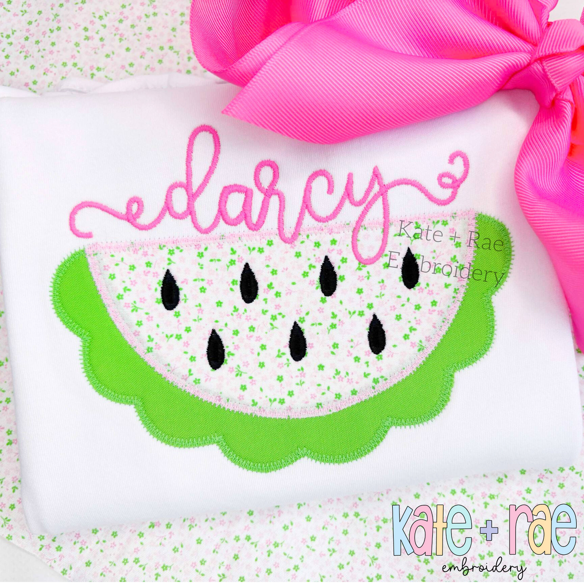 Watermelon Zigzag Applique Embroidery Design: Scalloped watermelon applique with a speckled center below the name darcy in pink script on a white shirt
